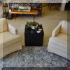 F10.Pair of ivory-colored club chairs. 